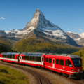 Red Swiss train Glacier Express passing through the Swiss Alps with Matterhorn mountain in the background