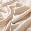 Close-up comparison of silk and cotton fabrics showing texture, weave, and comfort differences